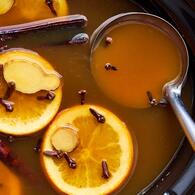 Apple Cider with Orange Slices, Clove, Ginger, and Cinnamon Sticks